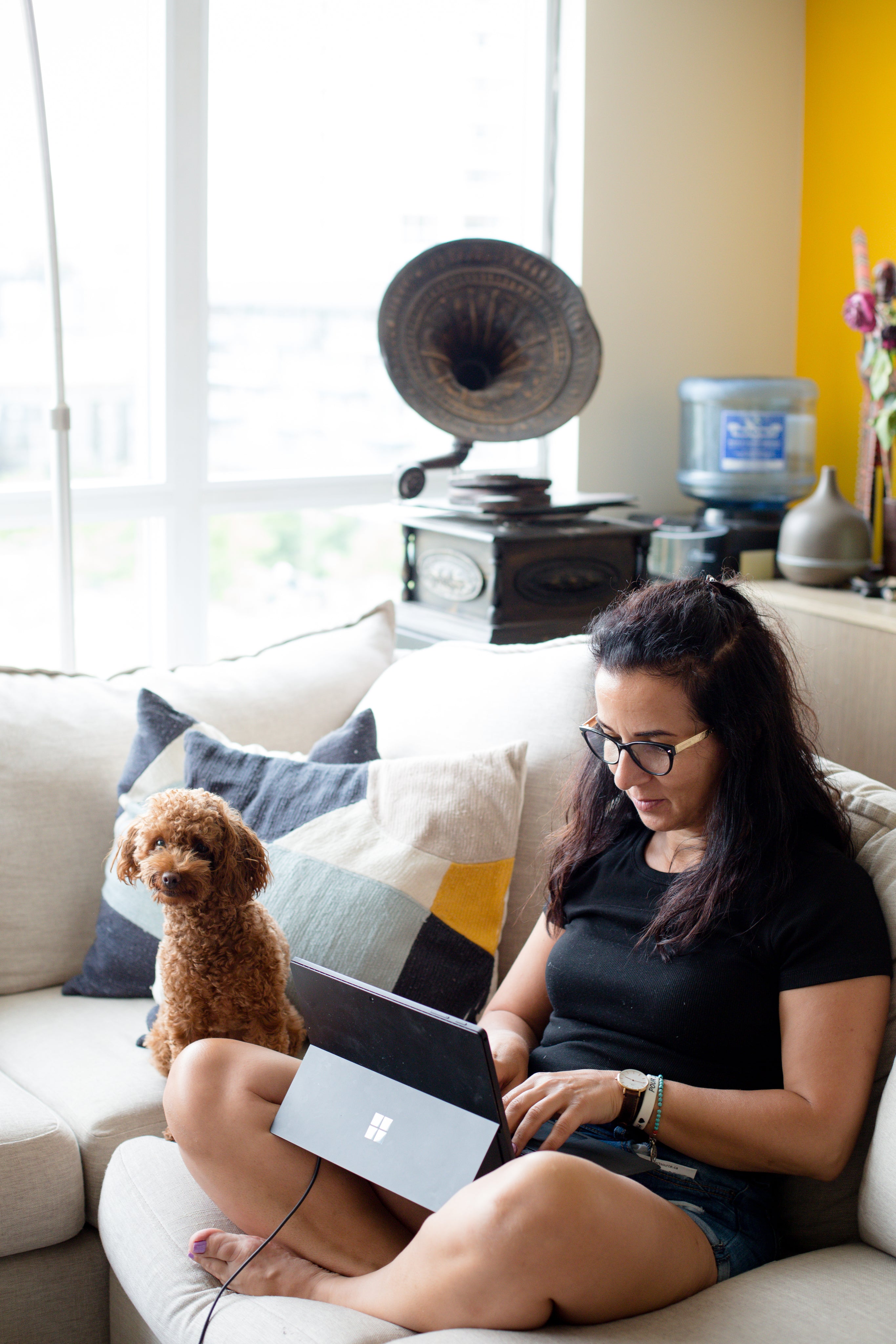 person-sits-on-their-couch-next-to-their-dog.jpg